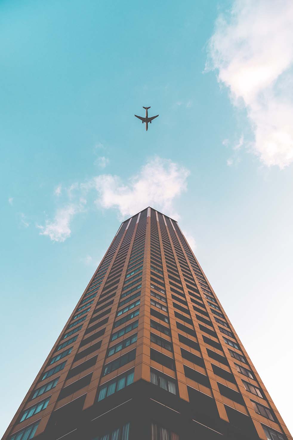 Plane Flying Over Building